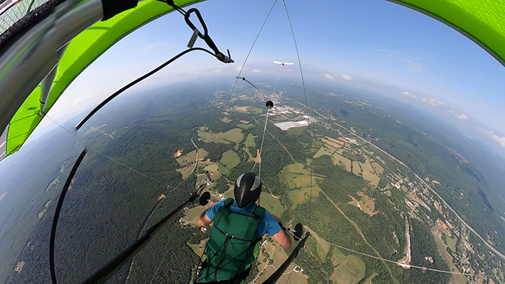 Hang glider pilot releasing from tow at altitude
