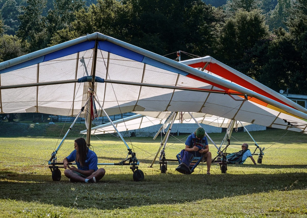 Tug pilots and hang gliders waiting for conditions at the flight park